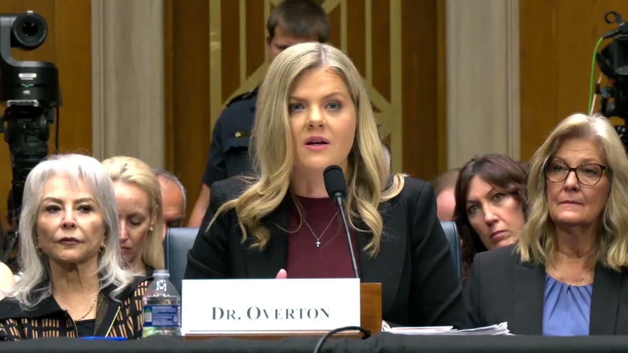 Dr. Heidi Overton answering at the witness table